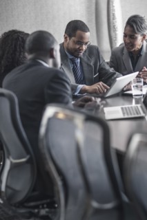 Business people using digital tablet in meeting