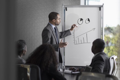 Businessman talking to colleagues in meeting