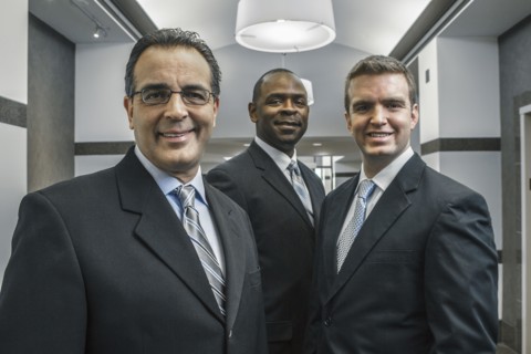 Businessmen smiling in office corridor