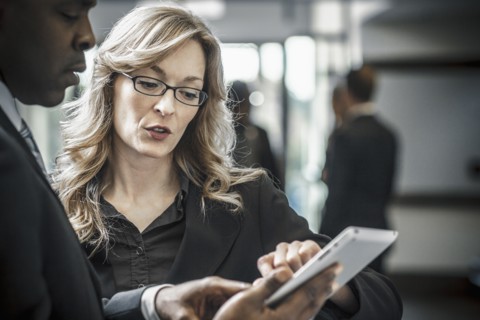 Business people using digital tablet in office