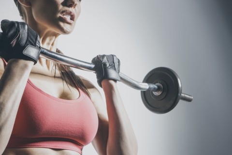 Caucasian woman lifting barbell