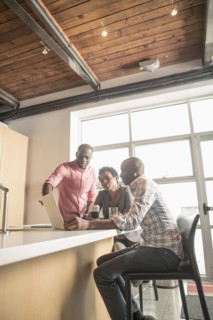 Business people talking in office kitchen