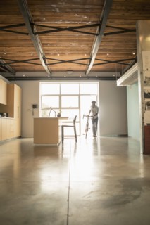 Black businessman with bicycle in office kitchen