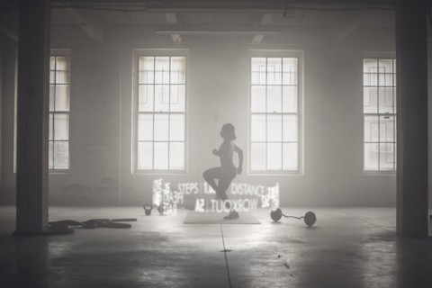 Virtual words circling Black athlete while working out
