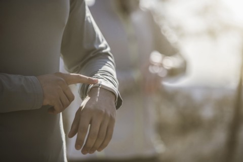 Close up of athlete checking sports watch