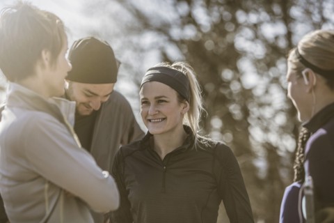 Smiling friends talking outdoors