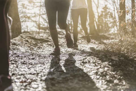 Runners jogging on dirt path