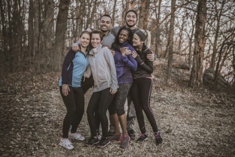 Runners smiling on forest path