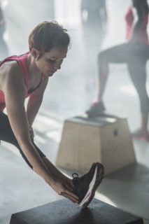 Athlete stretching leg in gym