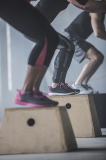 Athletes jumping on platforms in gym
