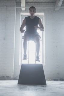 Athlete jumping on platform