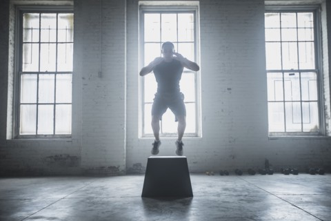 Athlete jumping on platform