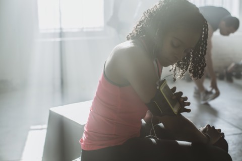 Athlete listening to mp3 player in gym