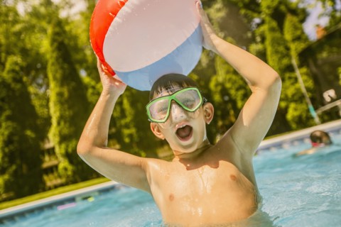 Caucasian boy playing in swimming pool