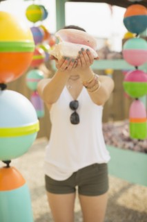 Caucasian woman holding conch shell