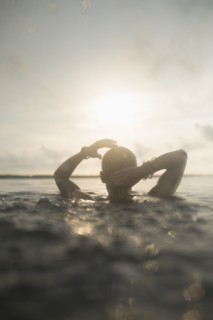 Caucasian woman swimming in still lake
