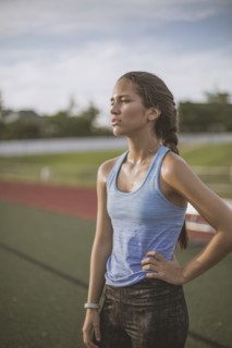 Mixed race athlete standing on sports field
