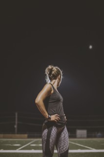 Caucasian athlete resting on sports field