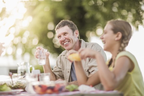 Caucasian family eating in backyard