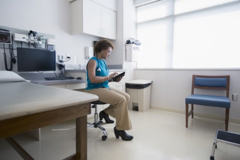 African American doctor using digital tablet