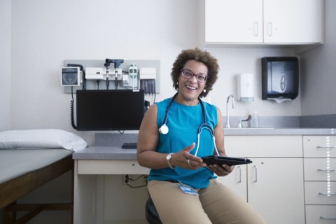 African American doctor holding digital tablet