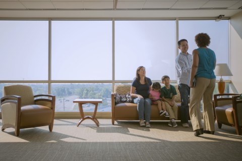 Doctor greeting patients in waiting room