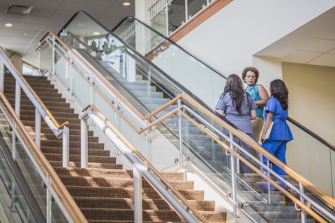 Nurses and doctor on hospital steps