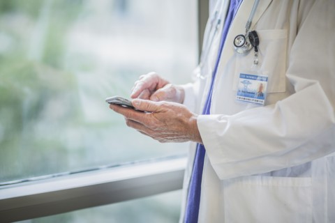 Caucasian doctor using cell phone