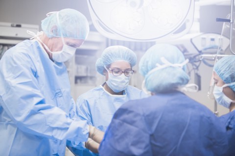 Surgeons working in operating room