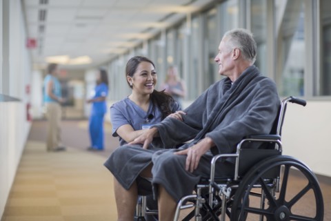 Nurse talking to patient in wheelchair