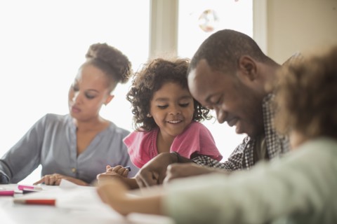 Family drawing together in kitchen