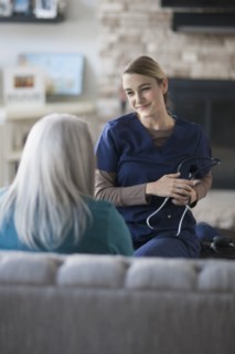 Nurse talking to patient in living room