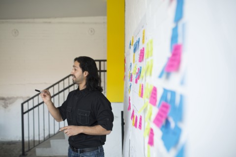 Mixed race businessman talking in office meeting