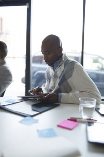 Businessman using digital tablet in office meeting