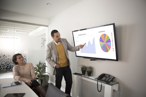 Businessman pointing to charts in meeting