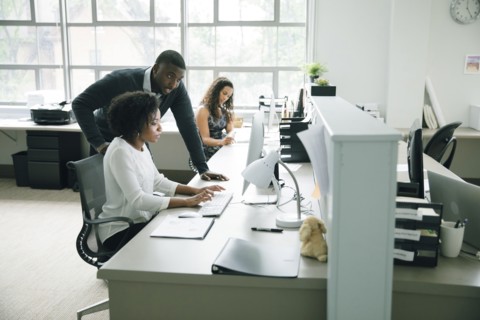 Business people using computer in office