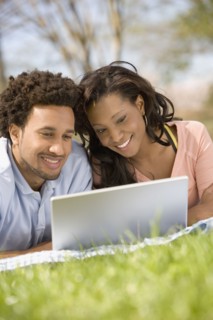 African American couple looking at laptop
