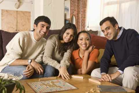 Multi-ethnic family playing board game