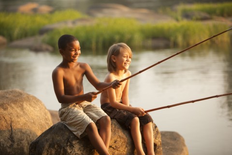 Smiling boys fishing together