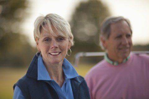 Couple standing on golf course