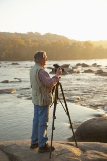Man taking photographs on beach