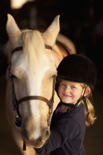 Caucasian girl standing with horse