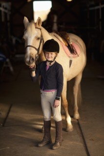Caucasian girl standing with horse