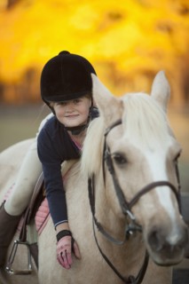 Caucasian girl riding on horse