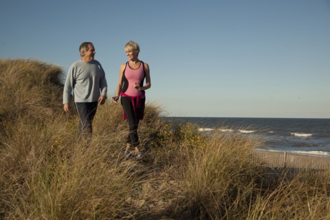 Couple exercising near ocean