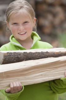 Caucasian girl carrying firewood