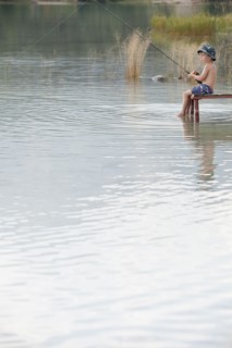 Caucasian boy fishing in lake