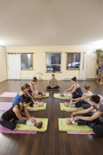 Mothers and babies taking yoga class