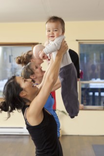 Mothers and babies taking yoga class