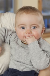 Caucasian baby chewing fingers